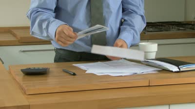 stock-footage-wide-shot-pan-of-a-businessman-opening-a-letter