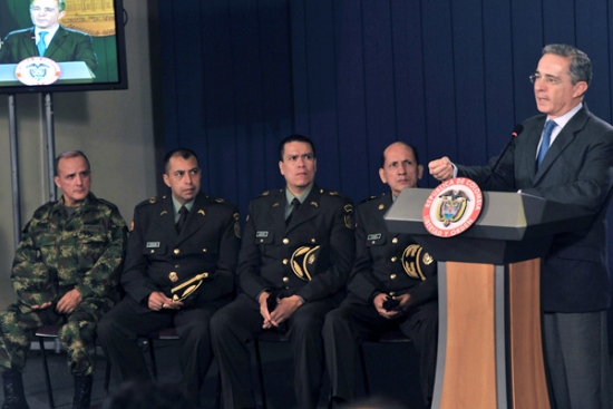 Colombian President Alvaro Uribe (R) spe